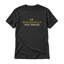 In Blockchain We Trust original artwork on a black heather t-shirt, upright relaxed flatlay on pure white