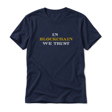 In Blockchain We Trust original artwork on a navy t-shirt, upright relaxed flatlay on pure white